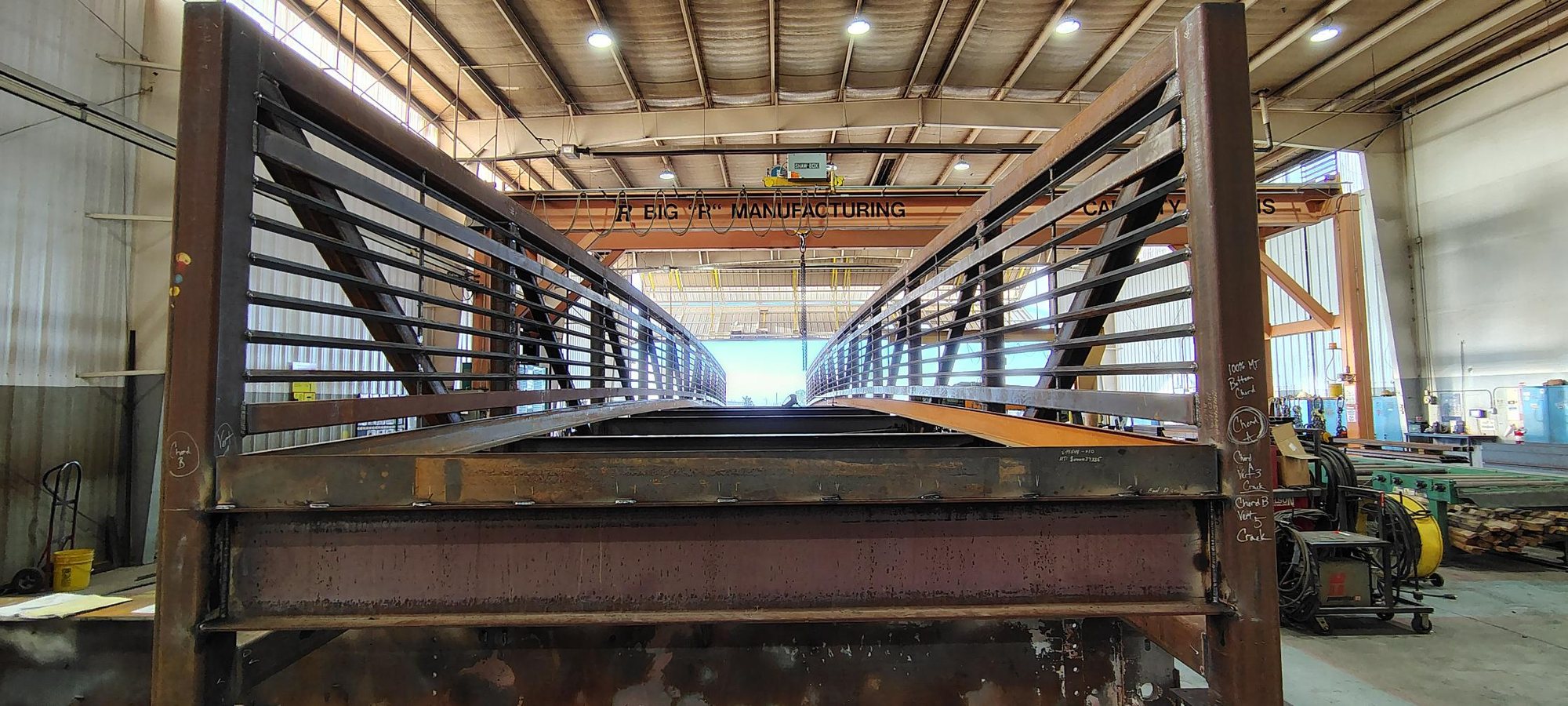 Welded steel bridge with pipe railings inside the shop