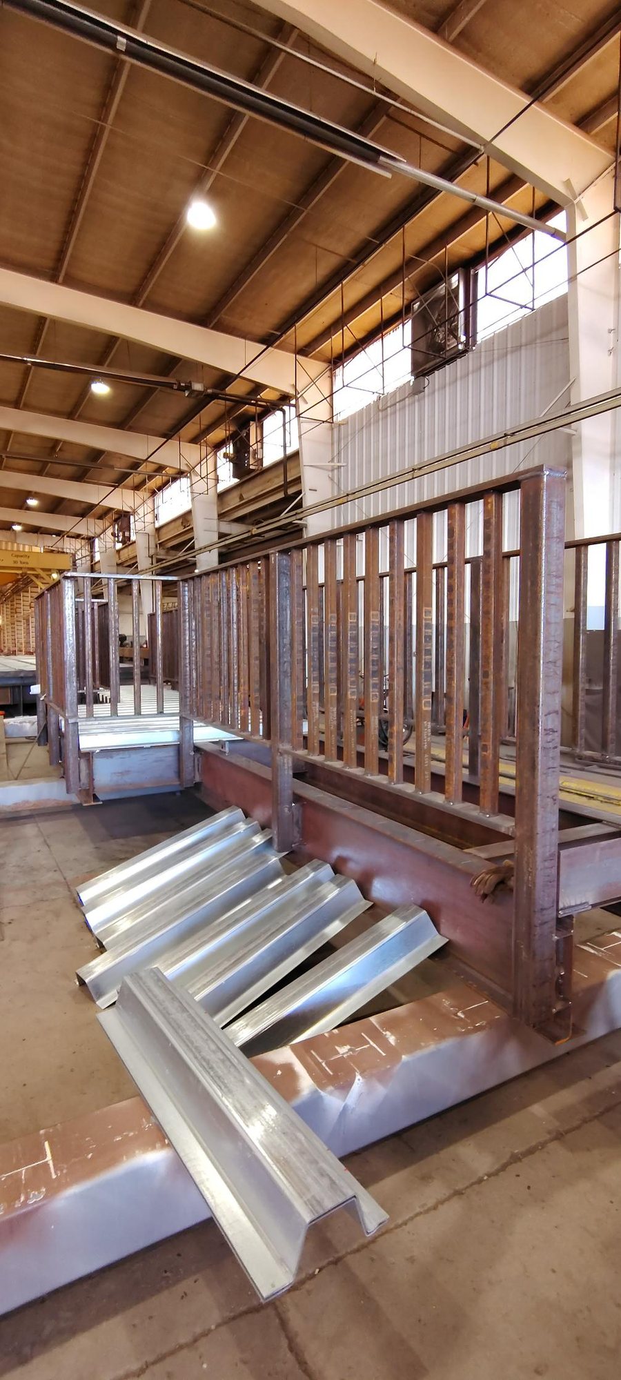 Steel railing panels and galvanized decking on a bridge frame