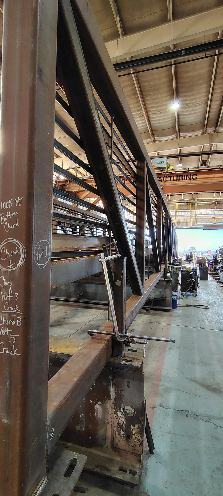 Clamped steel truss and railing during fabrication