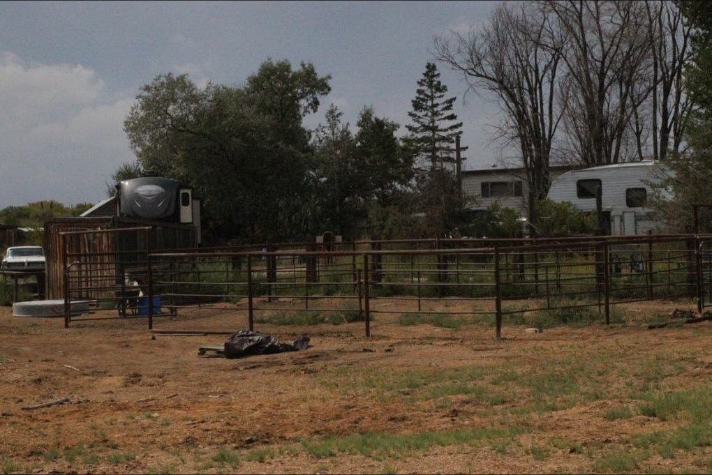 Pipe corral panels and a gate on a ranch lot