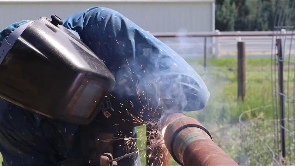 Welding a steel irrigation pipe in the field