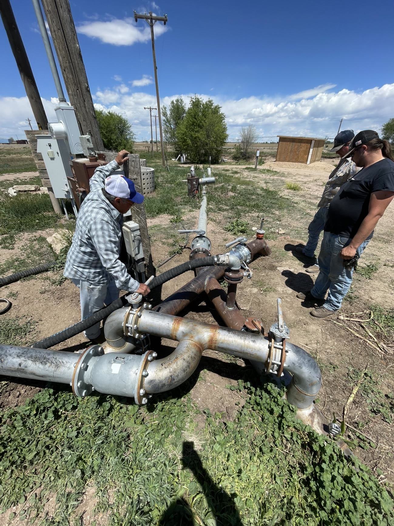 Flanged steel irrigation tie-in with valves at a well