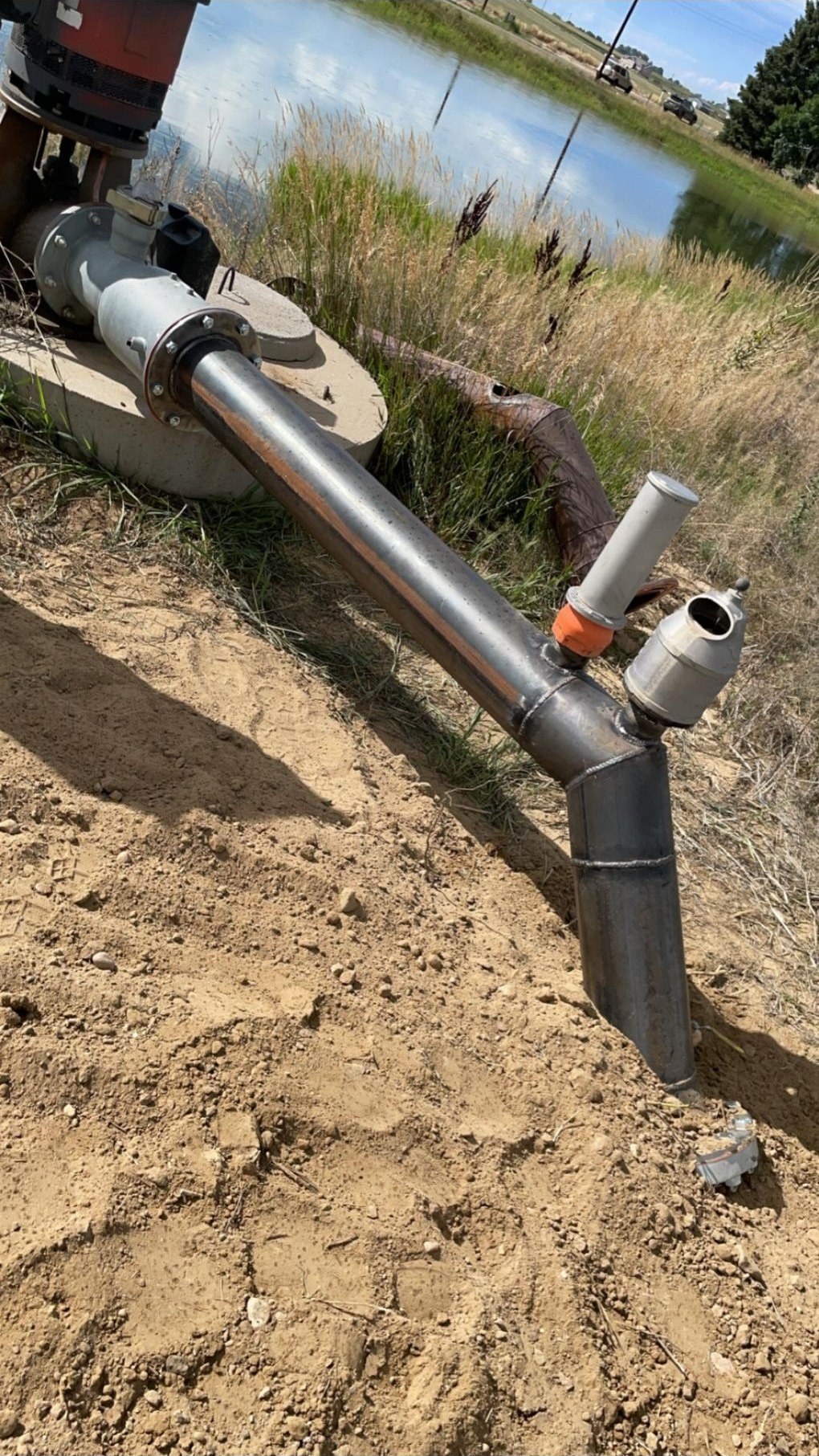 Steel pipeline from a pond pump, flanged and set into the ground